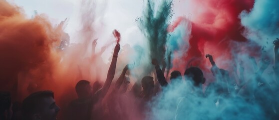 An ecstatic crowd immersed in vibrant clouds of blue and red during a lively festival celebration.