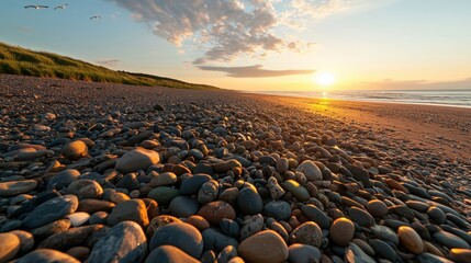 Obraz premium Serene Beach Sunset with Colorful Pebbles