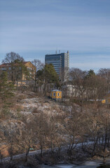 A gazebo on a cliff apartment and the skyscraper DN skrapan and office buildings in the block Marieberg, a sunny winter day in Stockholm