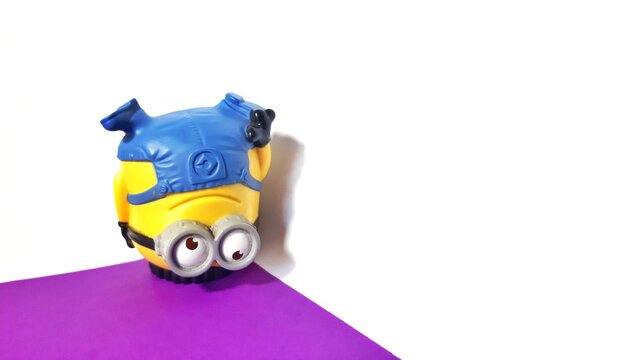 Jakarta, Indonesia July 21, 2023 minion jerry is breakdancing on a white background and purple base 