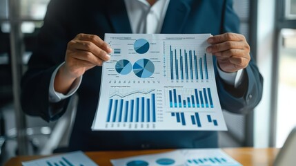 Businessperson presenting financial charts and graphs.