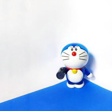 Jakarta, Indonesia July 21, 2023 doraemon with air canon gadget on a white background and blue base