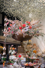 Elegant interior decor with white seating, golden candelabras, and floral arrangements