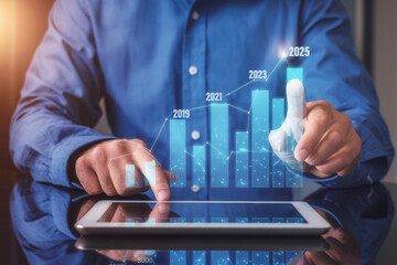 A person analyzes data trends on a tablet, highlighting growth with a digital graph in a professional setting.