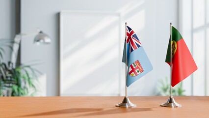 FLAGS OF FIJI AND PORTUGAL ON TABLE