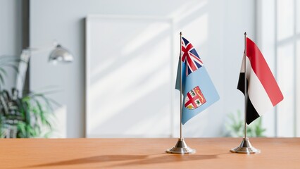 FLAGS OF FIJI AND YEMEN ON TABLE