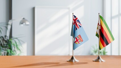 FLAGS OF FIJI AND ZIMBABWE ON TABLE
