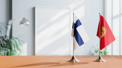 FLAGS OF FINLAND AND KYRGYZSTAN ON TABLE