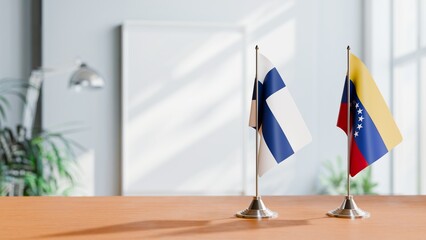 FLAGS OF FINLAND AND VENEZUELA ON TABLE