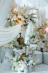Elegant interior decor with white seating, golden candelabras, and floral arrangements