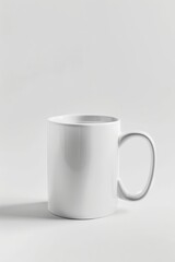 The white coffee mug sits on a clean surface, highlighting its minimalist design and smooth finish in gentle light