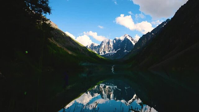 tamlaps, clouds are floating fast over a mountain lake and beautiful mountains in Altai