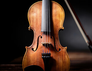 Fototapeta premium Close-Up Of A Wooden Violin Under Soft Lighting With Dark Background 