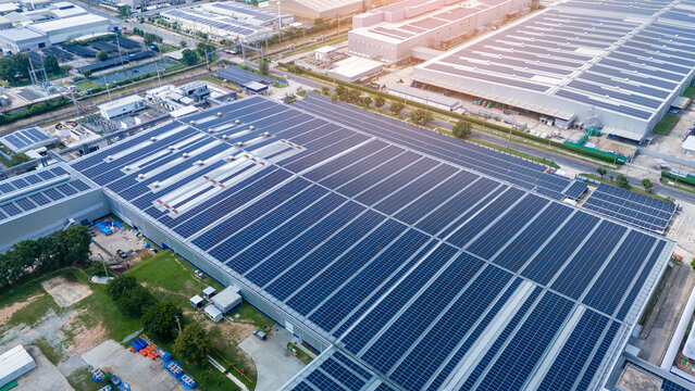 Top view Solar Cell on Warehouse Factory. Solor photo voltaic panels system power or Solar Cell on industrial building roof for producing green ecological electricity. Production of renewable energy.