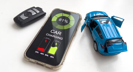 Mobile phone displaying Electric Car EV battery charging station charging in car port, efficient...