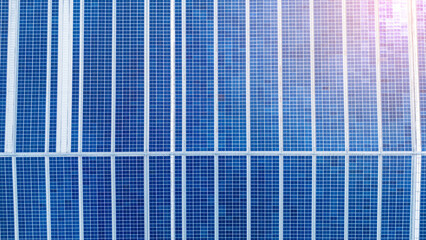 Top view Solar Cell on Warehouse Factory. Solor photo voltaic panels system power or Solar Cell on industrial building roof for producing green ecological electricity. Production of renewable energy.