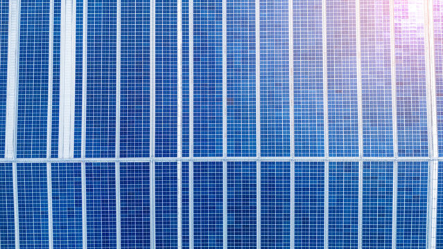 Top view Solar Cell on Warehouse Factory. Solor photo voltaic panels system power or Solar Cell on industrial building roof for producing green ecological electricity. Production of renewable energy.