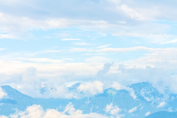Blurred mountains peak landscape. Blue white mountain nature background wallpaper, soft focus.