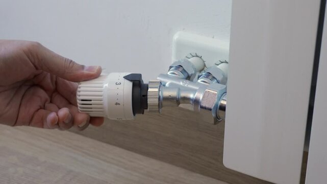 thermostatic valve being adjusted