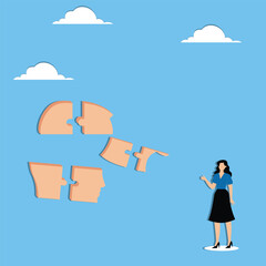 Businesswoman looking at the pieces of a jigsaw puzzle