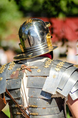 Roman legionary in metal armor at a Roman historical reenactment festival