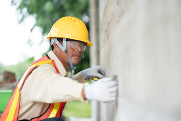 Skilled worker using measurement techniques in construction tasks with precision.