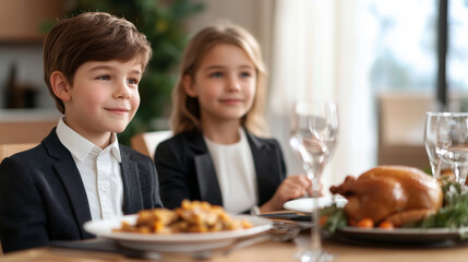 Brother and Sister Enjoying Thanksgiving Dinner A joyful brother and sister dressed in formal attire sit together at the Thanksgiving dinner table. In front of them is a delicious