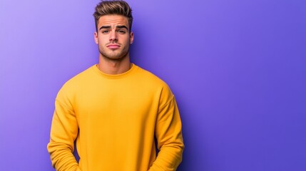 Obraz premium Unhappy young man with a clenched jaw and raised eyebrow, hands in his pockets, isolated on a blue-to-purple gradient background 