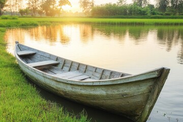 Obraz premium Wooden Boat Moored on a Tranquil Lake at Sunset