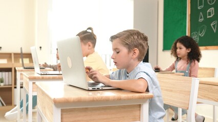 Caucasian smart child programing software system and learning about coding while multicultural...