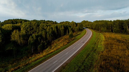 Naklejka premium the car is driving along a beautiful road