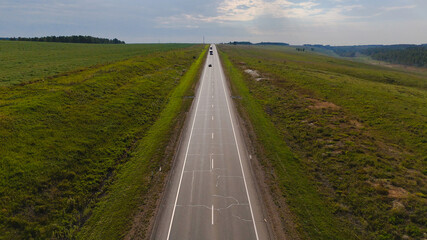 the car is driving along a beautiful road