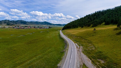 the car is driving along a beautiful road