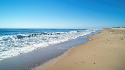 Fototapeta premium Long sandy beach with gentle waves and space for text in the wide horizon. Serene summer vibes