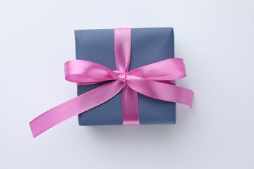 Beautiful gift box with pink bow isolated on white, top view