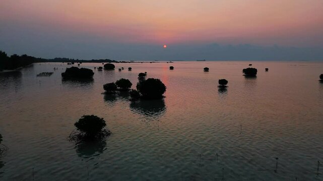 Aerial view of tropical beach and island at sunset, pari island north jakarta, indonesia