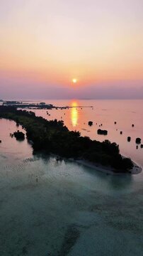 Aerial view of tropical beach and island at sunset, pari island north jakarta, indonesia