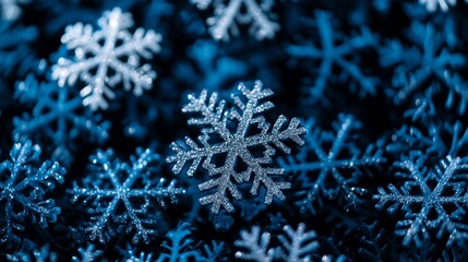 Snowflakes on a blue background, intricate patterns visible.