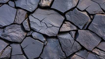 Dark lava stone texture with jagged black surfaces and natural cracks, giving an earthy, volcanic appearance on a plain background 