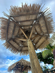 Tiki hut on a sandy tropical ocean beach vacation