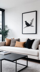 Minimalist living room with a white couch, black coffee table, and a framed black and white bird print.