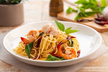 Stir Fried Spaghetti with Dried Chili and garlic with Shrimp in white plate.