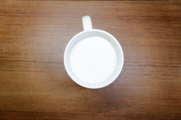 White Sugar in White Cup on Wood Background