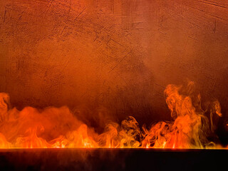 Bright flame against a concrete wall