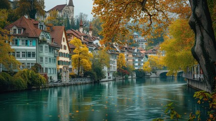 Obraz premium A river flows by buildings, lush trees creating a beautiful scene