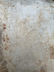 Textured concrete surface with rust stains and natural wear observed in an outdoor setting during daylight