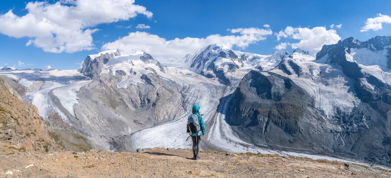 Hiker standing in front of Gornergletscher and Monte Rosa Massiv, Swiss Alps, Switzerland