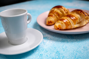 cup of coffee with croissant