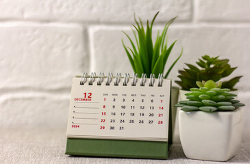 The calendar shows December 2024. Desk flip calendar. Hello, December.