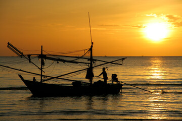 Fisherman and sunrise, Squid boat back home after going sea on sunset.